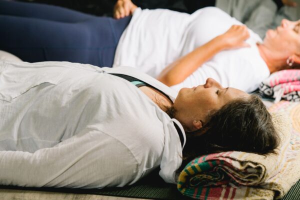 women practicing nature inspired yoga nidra during a yoga class