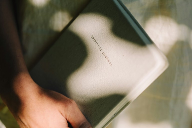 woman holding a journal during a retreat
