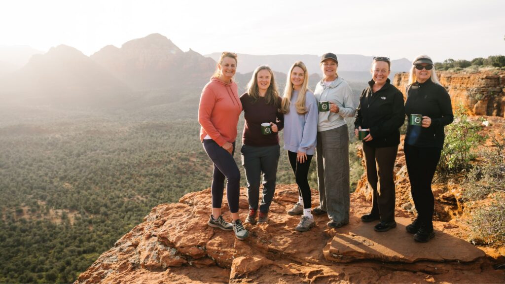 women at sunrise during a yoga retreat in Sedona